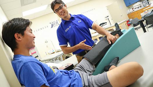 Athletic Training Graduate Student works with a patient